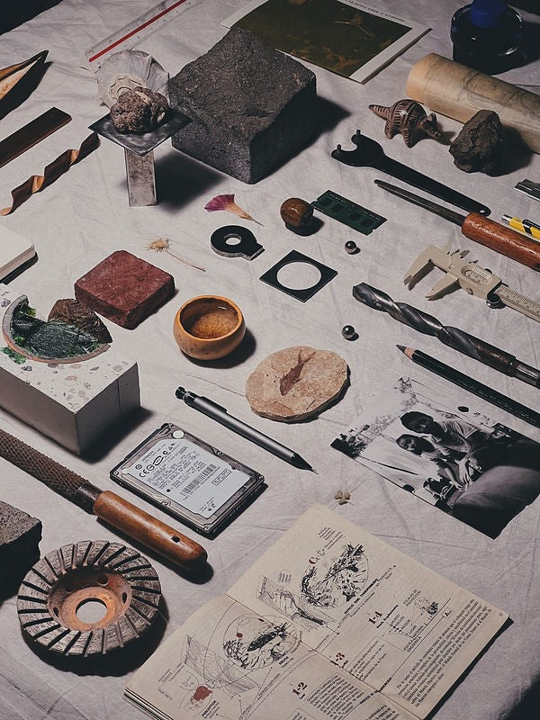 A collection of tools and objects laid out on a table